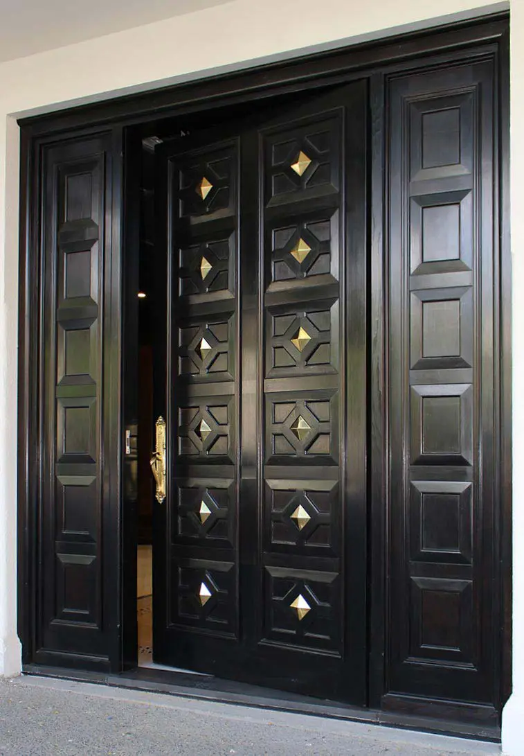 External Doors: A wooden door with a glass panel, surrounded by a brick wall and adorned with a brass doorknob